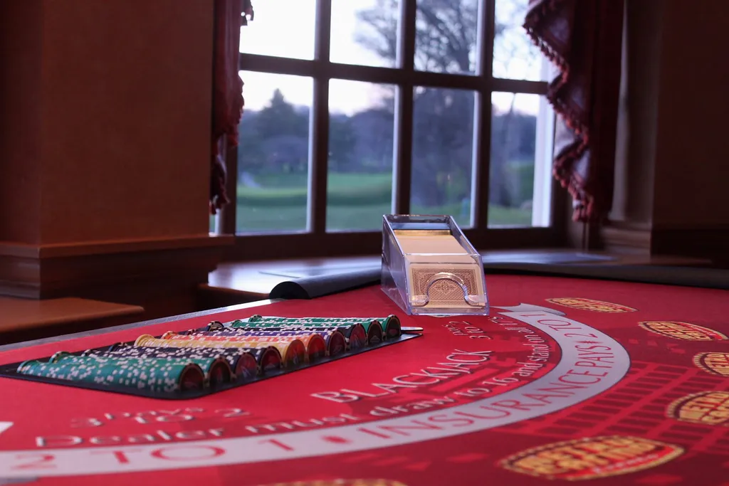 Casino chips and cards ready on a blackjack table