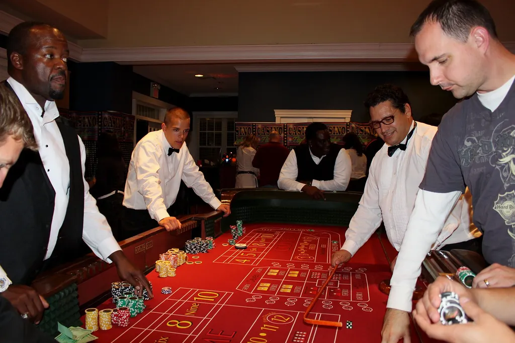 Dealers and guests around a craps table