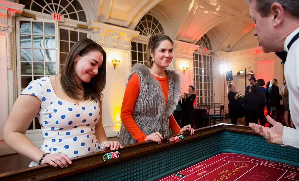 Two guests playing craps with a dealer